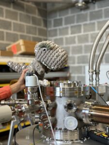 Dr Francesco Romano in his lab with a knitted mascot